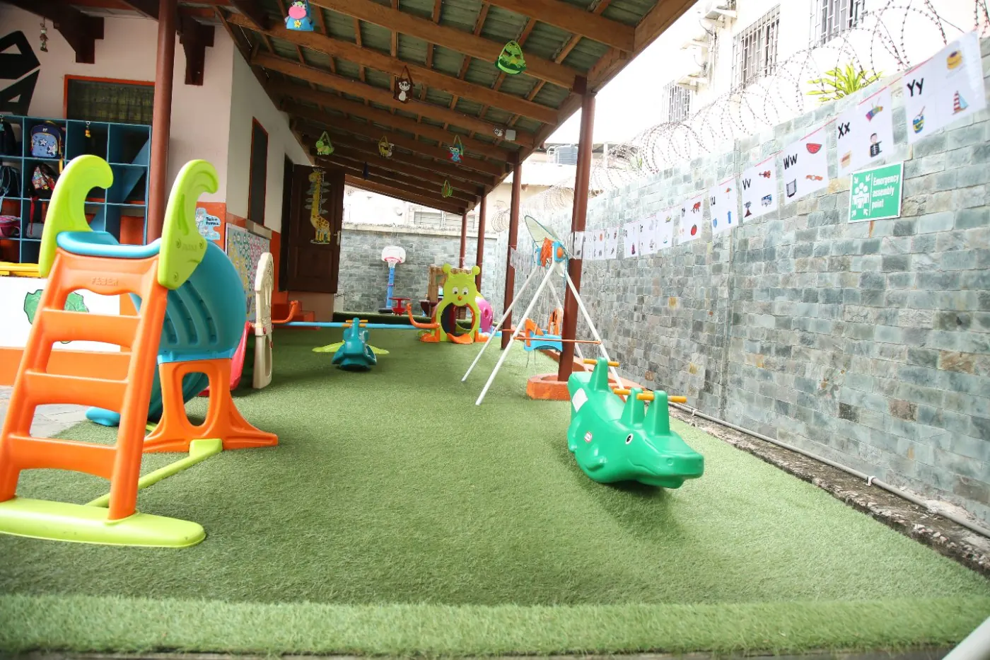 Slide, swings and play equipment on artificial grass