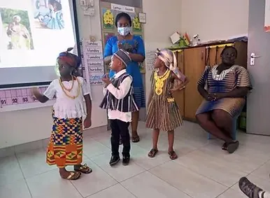 Children in traditional dress presenting to the class