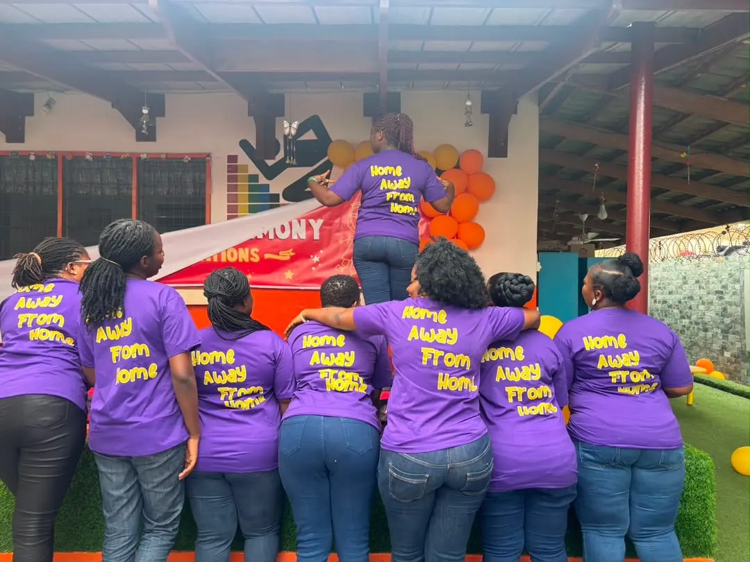 The Early Starters Aunties in matching purple 'Home Away From Home' T-shirts